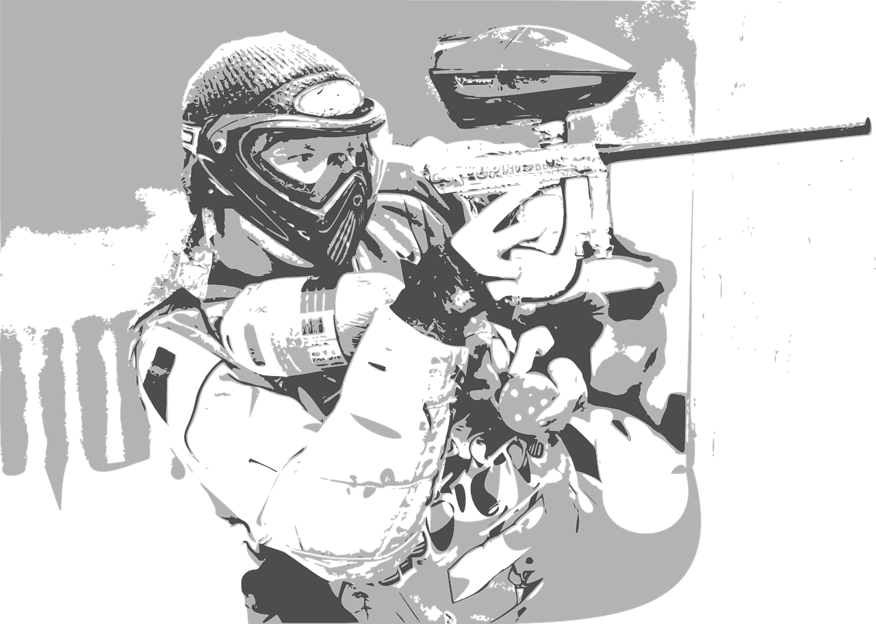 A greyscale image of a paintball player taking aim